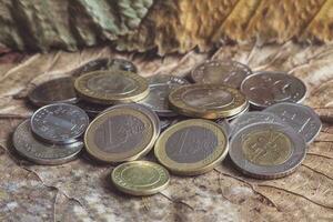 euro coins are scattered on the table photo