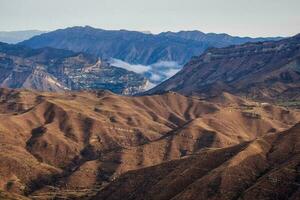 dramático alpino paisaje con alto montaña Valle en luz de sol y en sombra debajo nublado cielo. escénico montaña paisaje con cambiable clima en tierras altas. soleado y nublado. luz de sol y sombra foto