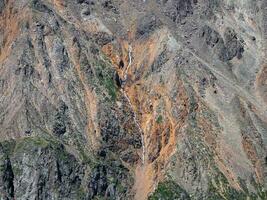 Texture of mountains. Aerial view of mountain gorge with a curved river line. photo