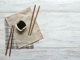 soy sauce and chopsticks on the table photo
