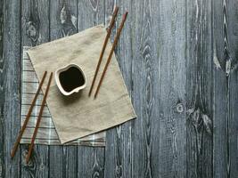 soy sauce and chopsticks on the table photo