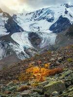 Dramatic natural background of the glacier surface with cracks The natural background of the ice wall and the glacier in the background. Beautiful natural texture of a dark glacier wall. Vertical view photo