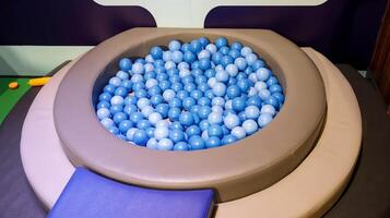 Kids ball pool full of blue and white plastic ball for indoor kids activities. photo