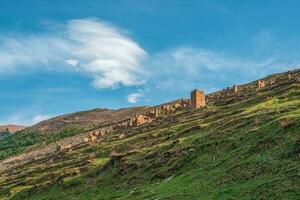 Ruins and towers of the aul ghost Goor in Dagestan in the evening light. Russia. photo
