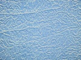 Crumpled blue brocade fabric texture background photo