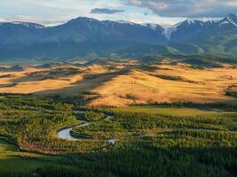 The passes, the mountains and rocks of Altai. Autumn landscape in clear weather with winding river. Warm sunlight and open space, freedom. photo