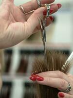 The position of the scissors when cutting hair. The technique of cutting hair with scissors. photo