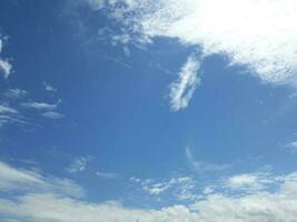 white clouds dotted the blue sky photo
