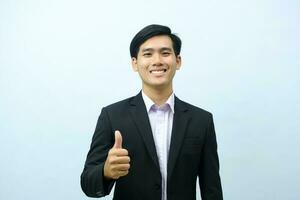 Portrait of businessman showing thumb up. photo