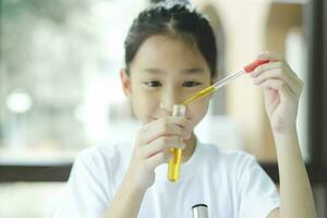 Little child with learning science class in school laboratory photo
