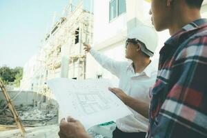 The engineering team working at building site meeting and discussing. photo
