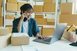 Young online business owner talking with customer on the phone. photo