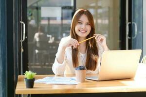 Happy businesswoman relaxing at office desk photo