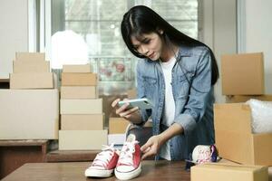 Online seller owner take a photo of product for upload to website online shop.