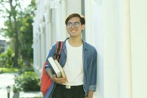 Student standing outdoor and holding books. photo