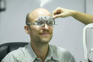 Man examining eyesight in optical clinic. photo