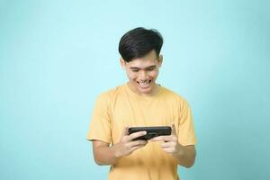 Young man using mobile phone playing online game photo