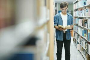 Student reading book at library. photo