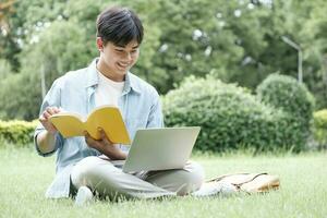 Collage student using laptop in the park. photo