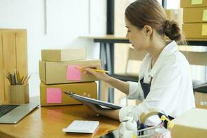 Female entrepreneur checking order preparing for delivery. photo