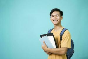 Confident student young man holding books. photo