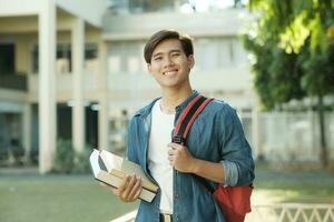 Student standing outdoor and holding books. photo