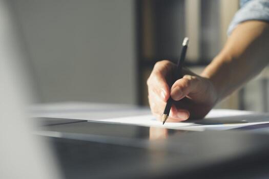 Close up of businessman working at office using laptop. photo