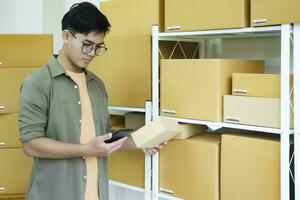 Online store owner checking orders for packaged product. photo