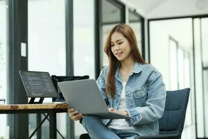 Young programmer or IT specialist satisfied with her work done. photo