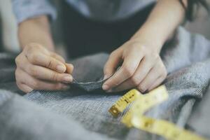 The tailor sawing the jacket photo