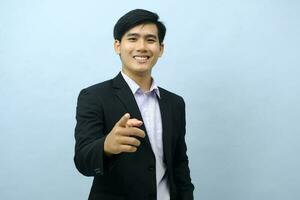 Portrait of businessman pointing at camera. photo