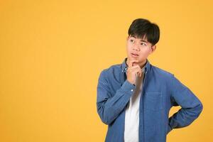 Thoughtful handsome young man standing and thinking photo