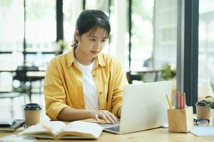 Young woman study in front of the laptop computer at home. photo