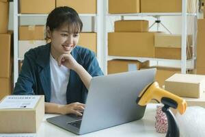 Young female small business entrepreneur working on laptop. photo