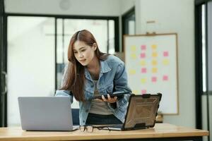 Young female programmer working on laptops. photo