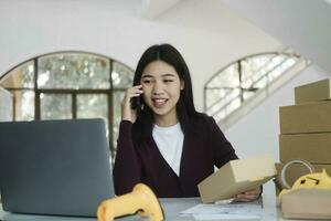 Female online business, store owner talking to customer using smartphone. photo