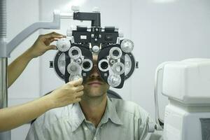 Man having eye test using phoropter. photo