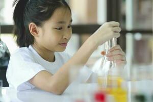 Little child with learning science class in school laboratory photo