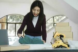 Businesswoman folding clothes for online order. photo