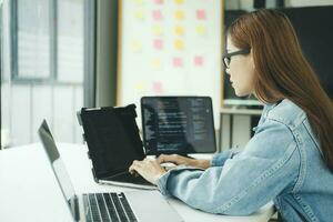 Young programmer or IT specialist satisfied with her work done. photo