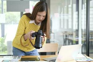 Young Asian Graphic Designer Working on Computer. photo