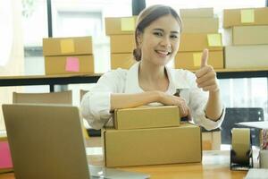 Female online business owner happy and giving thumb up. photo