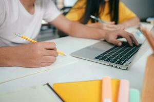 Young students campus helps friend catching up and learning. photo