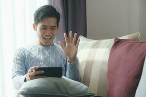 Young man using mobile device for video call. photo