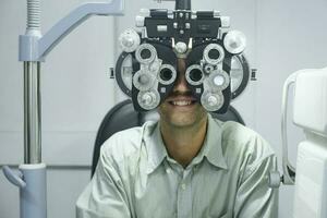 Man having eye test using phoropter. photo