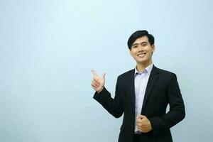 Portrait of businessman pointing and looking at camera. photo