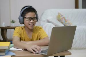 Young collage student using computer and mobile device studying online. photo