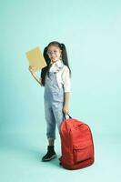 kid students girl smiling holding book, going to school. photo