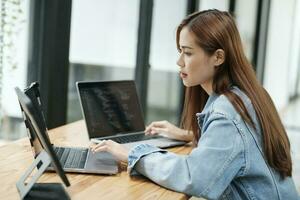 Young female programmer working on laptops. photo