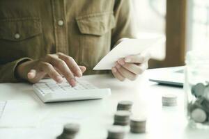 Accountant using calculator for calculate finance report in office photo